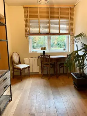 a dining room with a table and chairs and a window at Domaine Bourgogne en Grez 