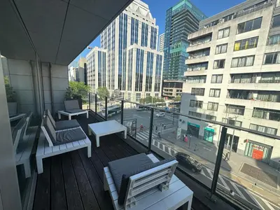 a balcony with benches and a view of a city at 3 Bedroom Apartment in City Center with Balcony View in Brussels