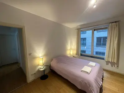 a bedroom with a bed with two lamps and a window at 3 Bedroom Apartment in City Center with Balcony View in Brussels