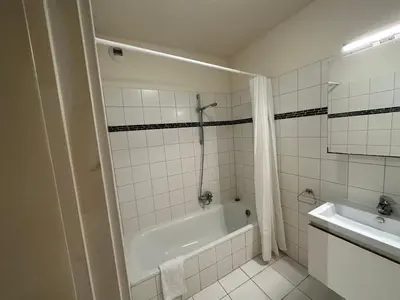 a white bathroom with a tub and a sink at 3 Bedroom Apartment in City Center with Balcony View in Brussels