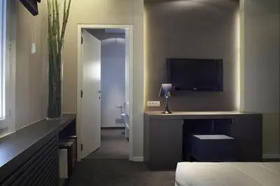 a bedroom with a bed and a desk with a television at Gravenhof in Beersel