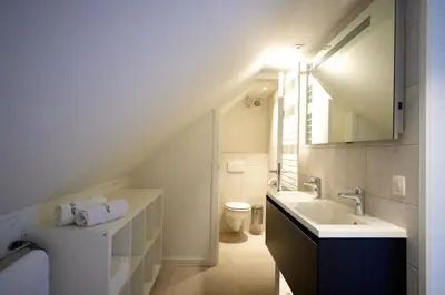 a bathroom with a sink and a toilet at Apartment with a view and parking in Brecht