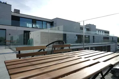 a wooden bench sitting on top of a building at ApartHotel Dénia in Lochristi