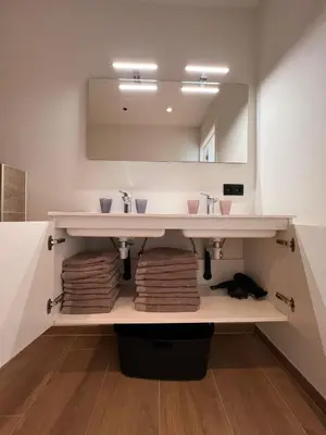 a bathroom with a sink and a mirror at ApartHotel Dénia in Lochristi