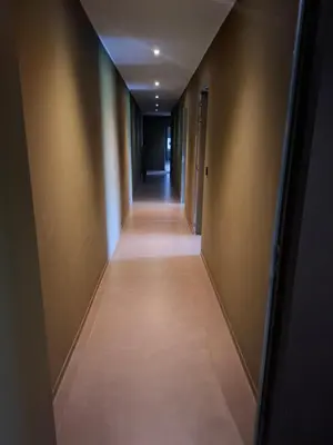 an empty hallway with a long corridor at B&B Finis terrae in Lokeren