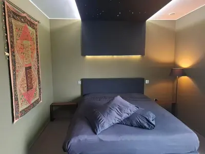 a bedroom with a bed with a blue pillow on it at B&B Finis terrae in Lokeren
