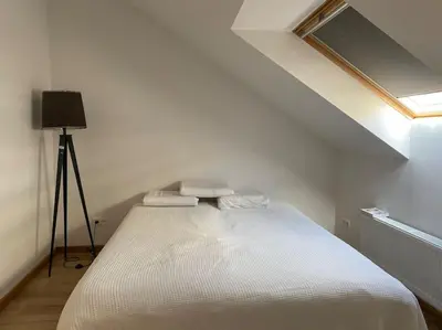 a white bed in a room with a window at Spacious app/Antwerp city center #003 in Antwerp