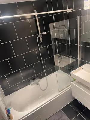 a bathroom with a shower and a tub and a sink at Bruxelles in Brussels