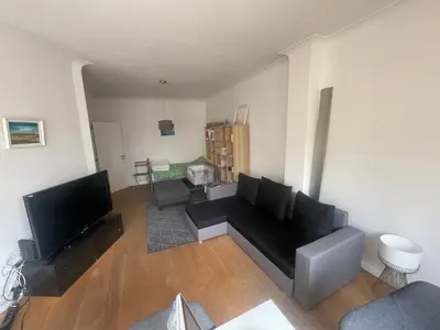a living room with a couch and a flat screen tv at Bruxelles in Brussels