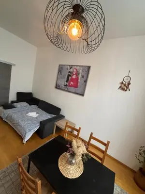 a living room with a table and a couch at L&L Residence 1 in Brussels