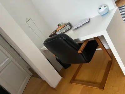 a black chair sitting at a white desk at L&L Residence 1 in Brussels