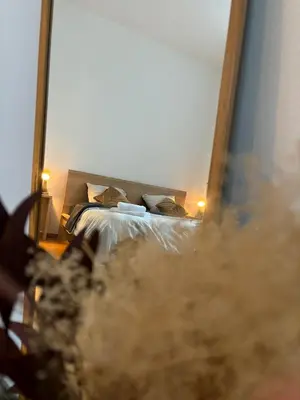 a reflection of a bed in a mirror at L&L Residence 1 in Brussels
