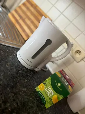 a toaster sitting on top of a counter next to a book at L&L Residence 1 in Brussels