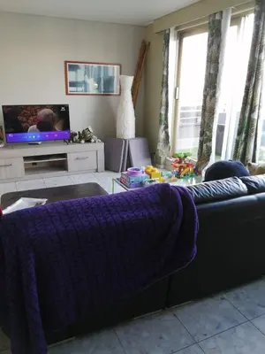 a living room with a couch and a tv at nys willy in Grimbergen