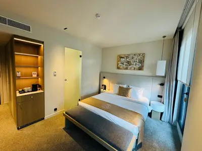 a hotel room with two beds and a window at OPO Hotel in Brussels