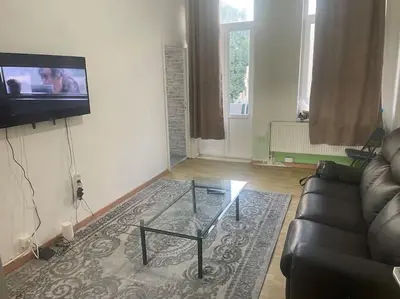 a living room with a couch and a glass coffee table at Bruxelles in Brussels