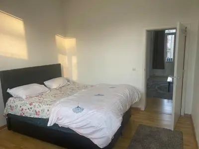 a bedroom with a large bed with white sheets at Bruxelles in Brussels