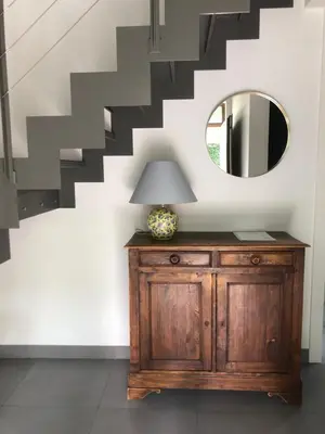 a mirror and a dresser in a room with stairs at landelijke villa met zwembad en gezellige openhaard in Zemst