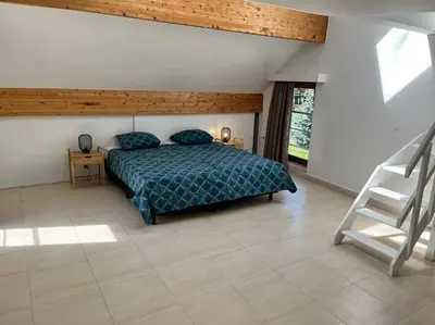 a bedroom with a bed and a chair in it at House Botanique in Meise