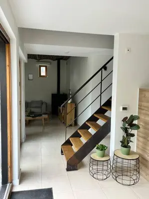 a hallway with a staircase in a house at House Botanique in Meise