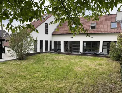 a house with a lawn in front of it at House Botanique in Meise
