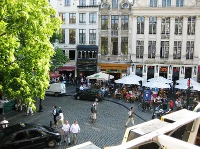 a group of people walking around a street in a city at Hotel The Moon in Brussels