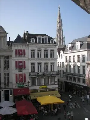 a group of buildings in a city with a church at Hotel The Moon in Brussels