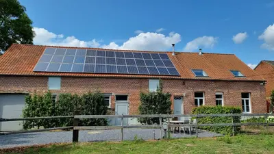 a house with solar panels on the roof at Boshovense Velden in Grobbendonk