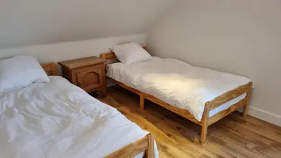 a room with two twin beds and a night stand at Boshovense Velden in Grobbendonk