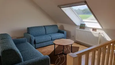 a living room with a couch and a table at Boshovense Velden in Grobbendonk