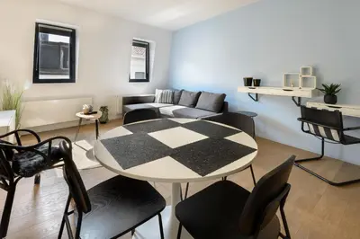 a living room with a table and a couch at R73 Apartments by Domani Hotels in Antwerp