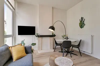 a living room with a couch and a table at New renovated condo's @ trendy south in Antwerp