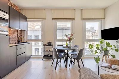 a kitchen and dining room with a table and chairs at New renovated condo's @ trendy south in Antwerp