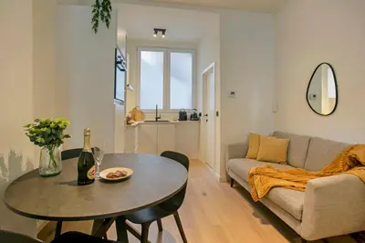 a living room with a table and a couch at New renovated condo's @ trendy south in Antwerp