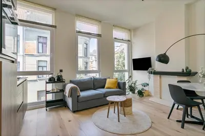 a living room with a couch and a table at New renovated condo's @ trendy south in Antwerp