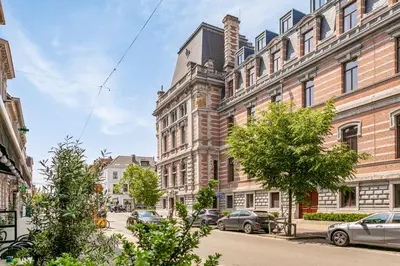 a city street with cars parked in front of buildings at New renovated condo's @ trendy south in Antwerp