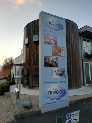 a sign in front of a building at Nuvola ULTIMO Resort in Zottegem