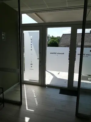 an empty room with a large window with a view of an airport at Nuvola ULTIMO Resort in Zottegem