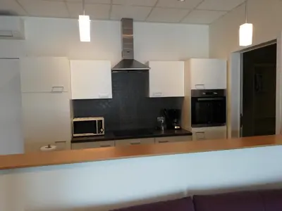 a kitchen with white cabinets and a microwave at Nuvola ULTIMO Resort in Zottegem