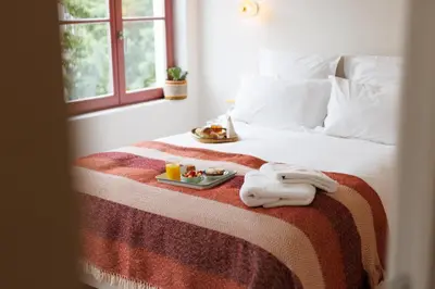 a bedroom with a bed with a tray of food on it at La Senne in Brussels