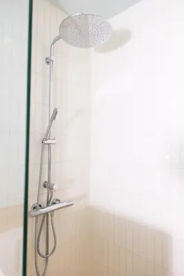 a shower with a shower head in a bathroom at La Senne in Brussels