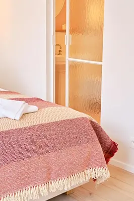a bedroom with a bed and a closet at La Senne in Brussels