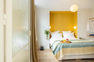 a bedroom with a bed with a tray of food on it at La Senne in Brussels