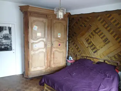 a bedroom with a wooden bed and a wooden door at ImpactHorizon in Brussels