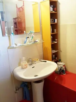 a bathroom with a white sink and a mirror at ImpactHorizon in Brussels