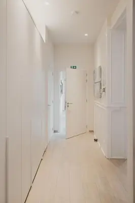 an empty hallway with white walls and a white door at Blue Bird Residence in Antwerp