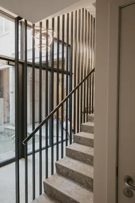 a staircase with black railings in a house at Blue Bird Residence in Antwerp