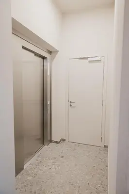 an empty corridor with a door in a white room at Blue Bird Residence in Antwerp