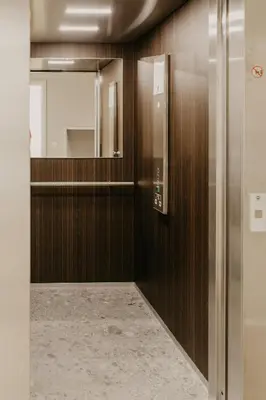 a bathroom with wooden walls and a mirror at Blue Bird Residence in Antwerp