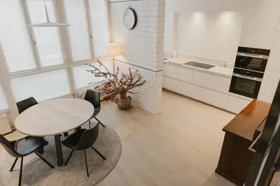 a kitchen with a table and chairs in a room at Blue Bird Residence in Antwerp